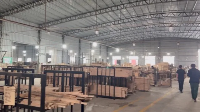 Wide view of the wooden-frame assembly workshop aisle
