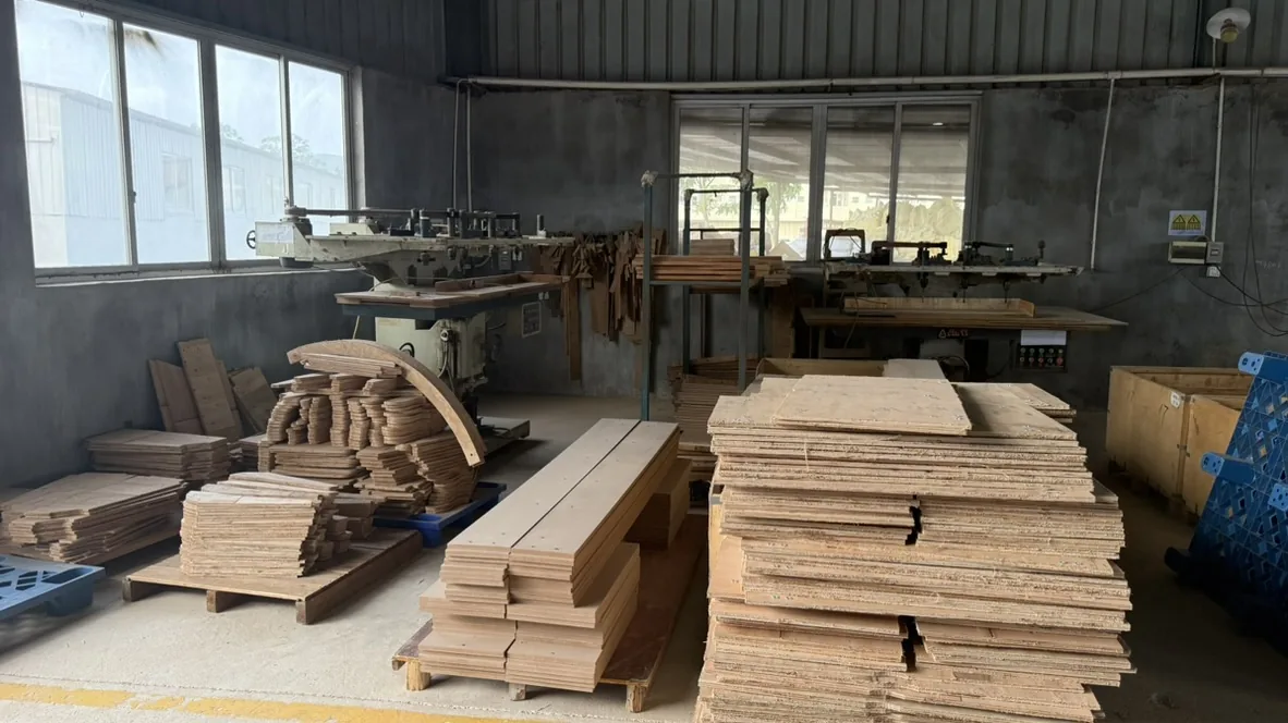 Woodworking equipment and shaped panels beside windows