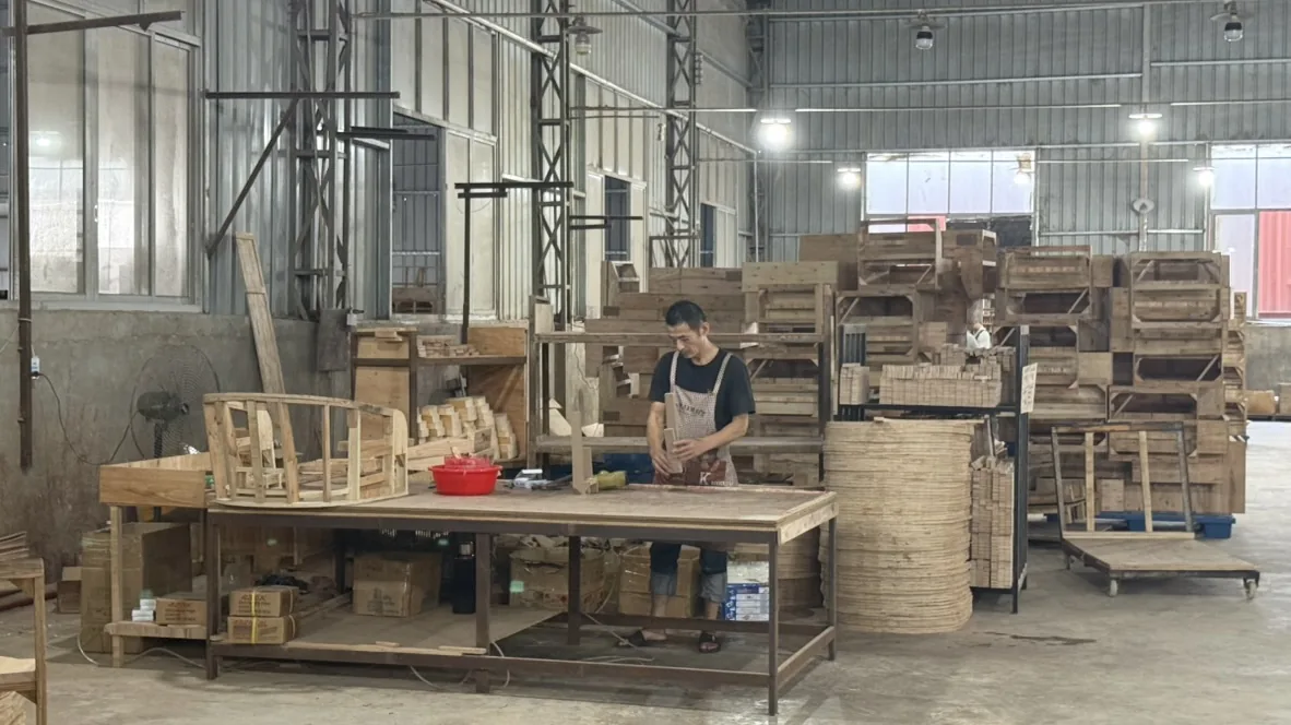 Workers assembling wooden chair frames