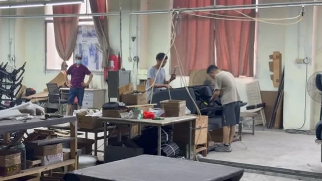 Work area with workers making upholstered chairs