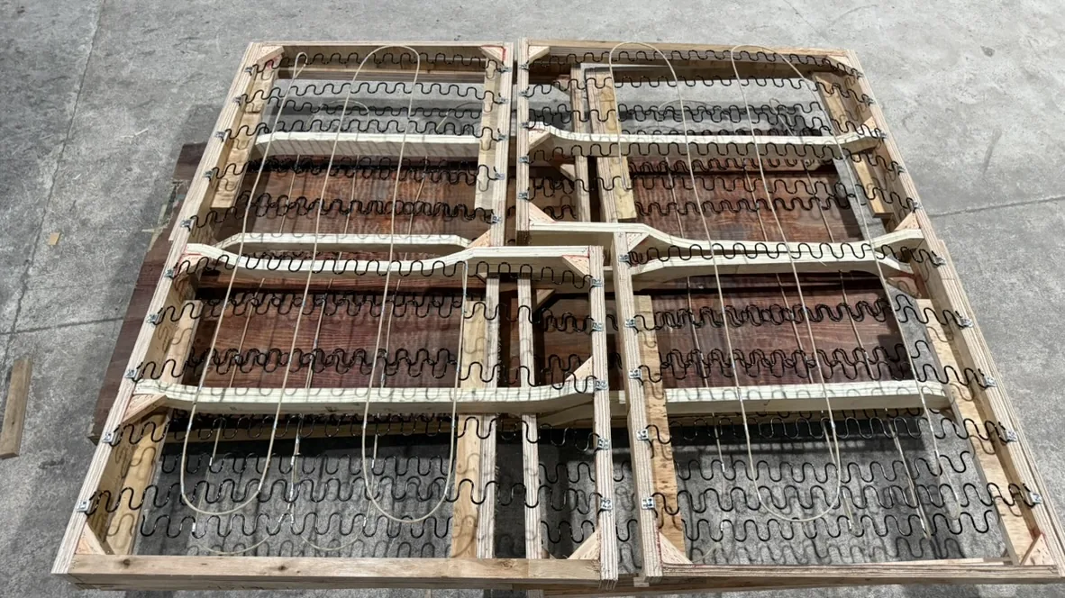 Close-up of sinuous springs fitted in a wooden seat frame