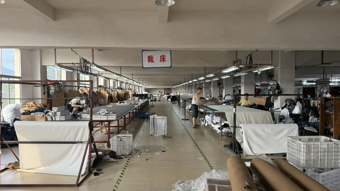 Long worktables and a central aisle in the cutting area