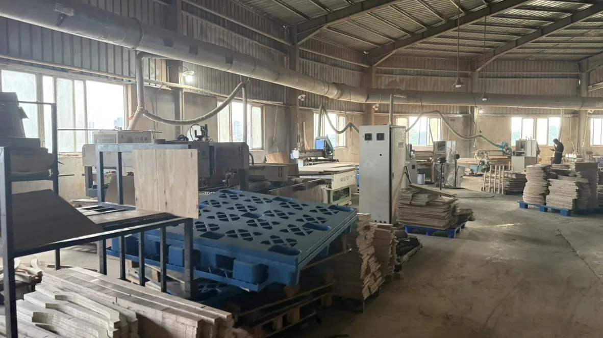 Blue pallets and panels in front of woodworking equipment
