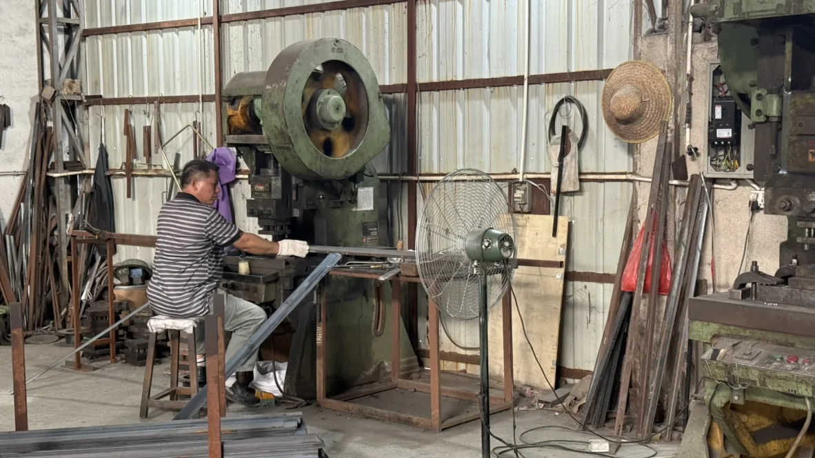 Worker operating flywheel metalworking equipment