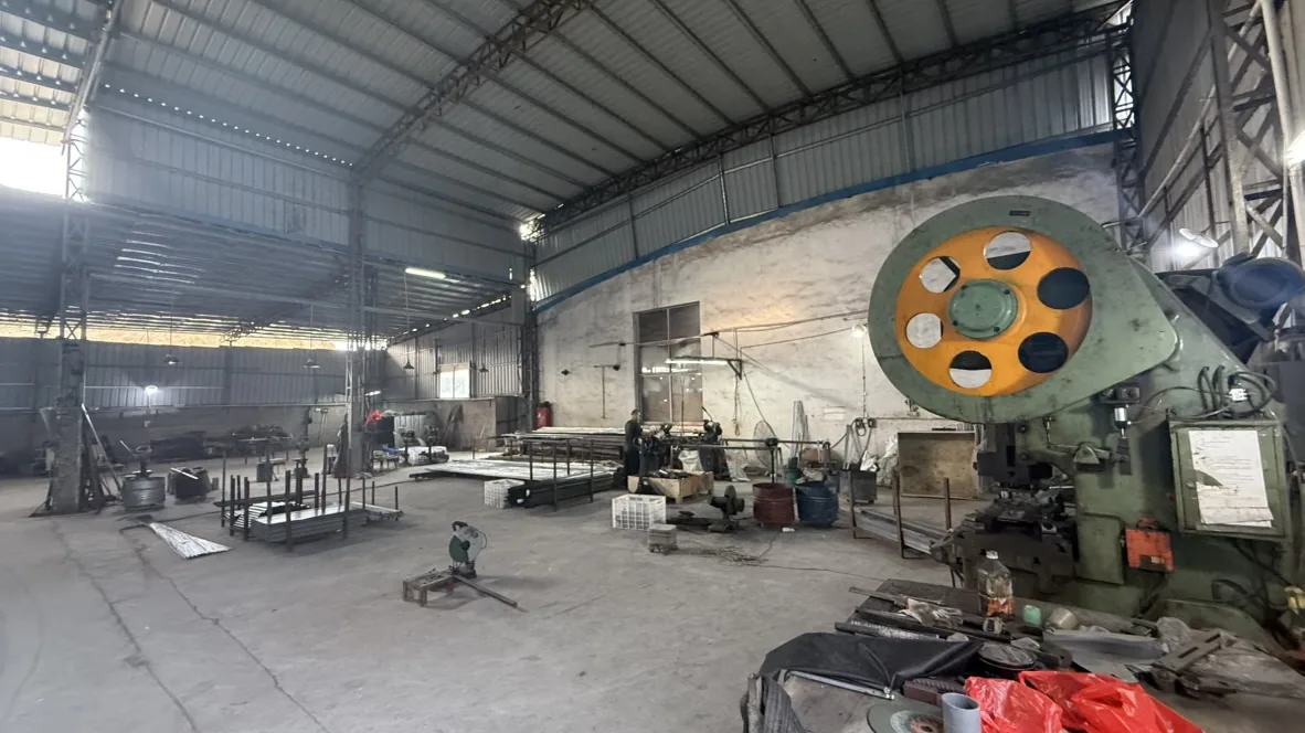 Wide view of the metalworking workshop and yellow flywheel equipment