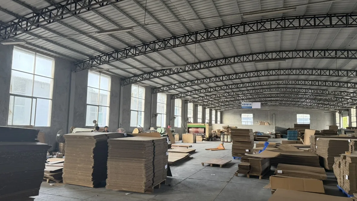 Wide view of a window-side aisle in the cardboard preparation workshop