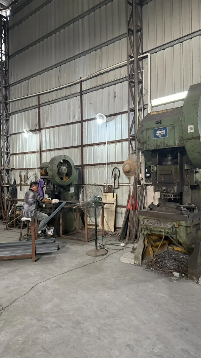 Portrait view of metalworking equipment and a worker