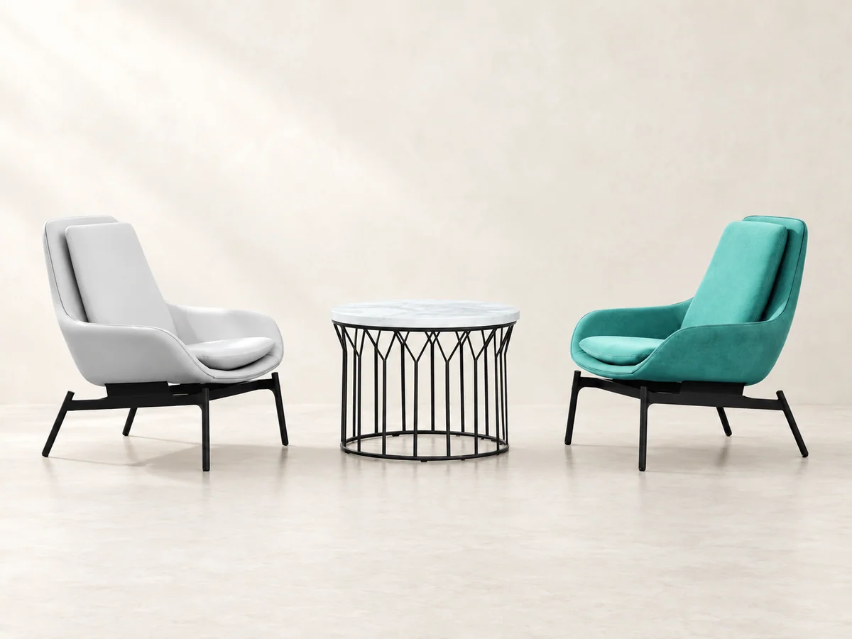 Grey and teal lounge chairs arranged around a round table for everyday conversations at home