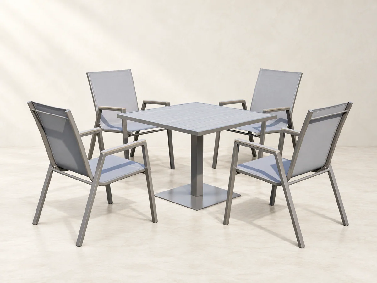 Square outdoor dining table with four grey mesh-seat metal chairs