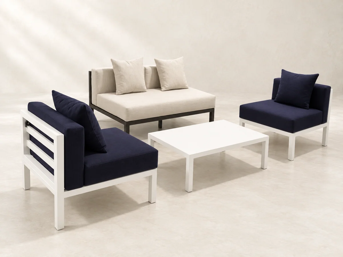 Oatmeal sofa, two dark-blue aluminium armchairs, and a white coffee table